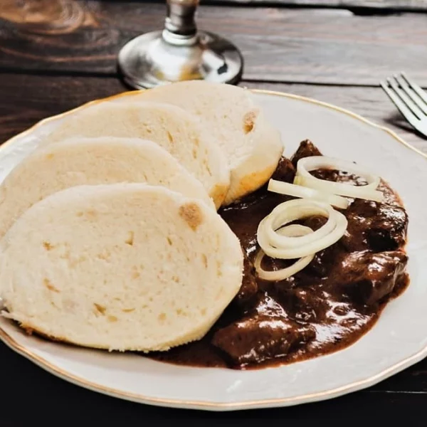BEEF GOULASH, BREAD DUMPLINGS, ONIONS